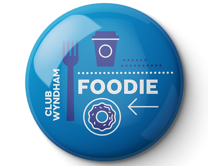 A blue "Foodie" Club Wyndham pin